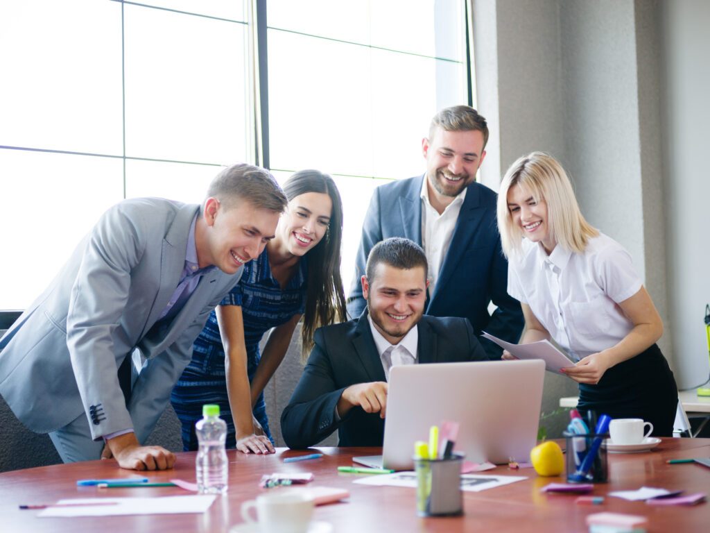 A,Group,Of,Office,Workers,Examining,Ideas,On,A,Laptop